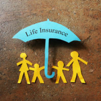 life insurance on blue umbrella with family cut out