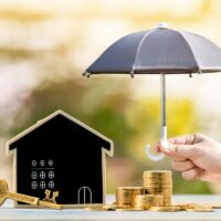 Blackboard house and stacked gold coin and master key and woman