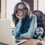 Close up photo beautiful she her business lady hands arms hold head chin not satisfied face look up check wall clock running of time all late meeting sit office chair wearing formal wear suit shirt