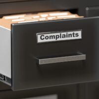 Complaints files and documents in cabinet in office. 3D rendered illustration.