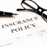 insurance policy form on desk in office showing risk concept