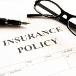 insurance policy form on desk in office showing risk concept insurance policy form on desk in office showing risk concept