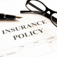 insurance policy form on desk in office showing risk concept insurance policy form on desk in office showing risk concept